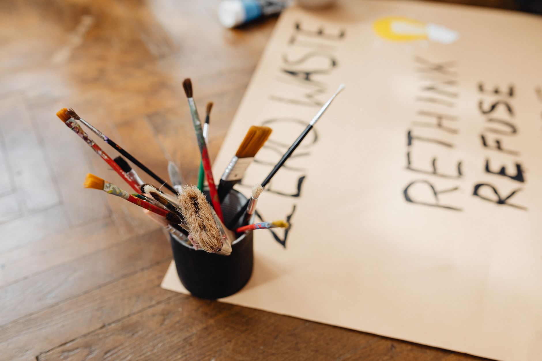Painting tools with a zero waste message in artistic setting.