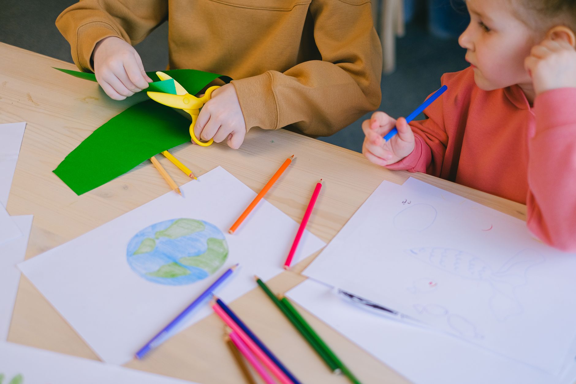 Children explore creativity with drawing and cutting activities focused on ecology.