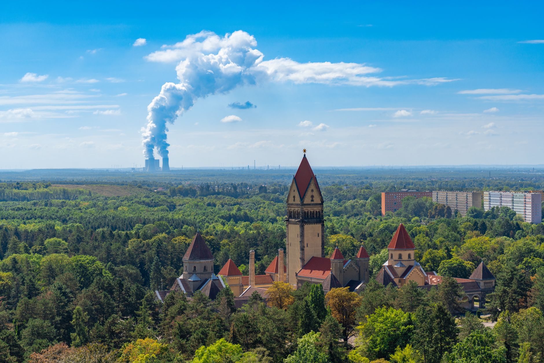 Aerial view of Leipzig with prominent incineration plant. Contrasting urban and green scenery.