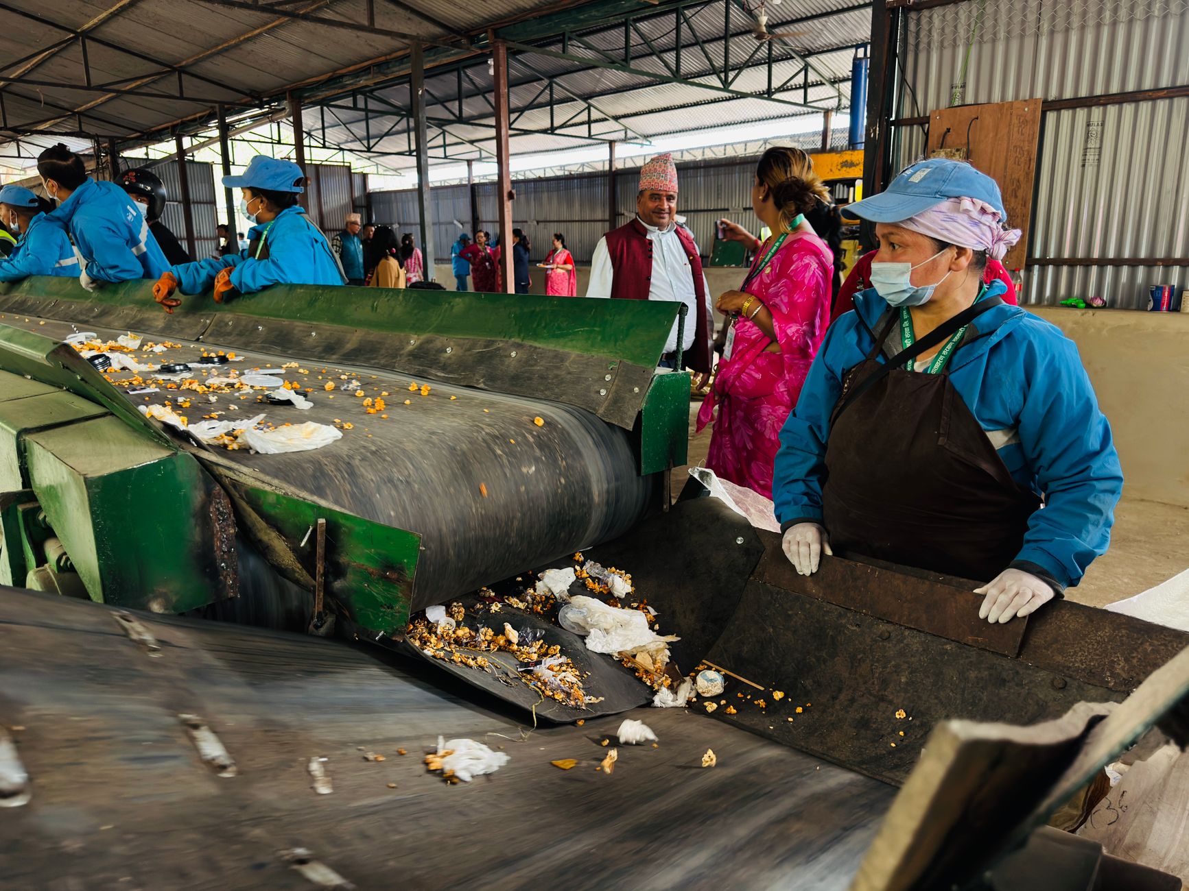 Workers sorting waste in a recycling facility in Butwal, Nepal, showcasing environmental sustainability efforts.