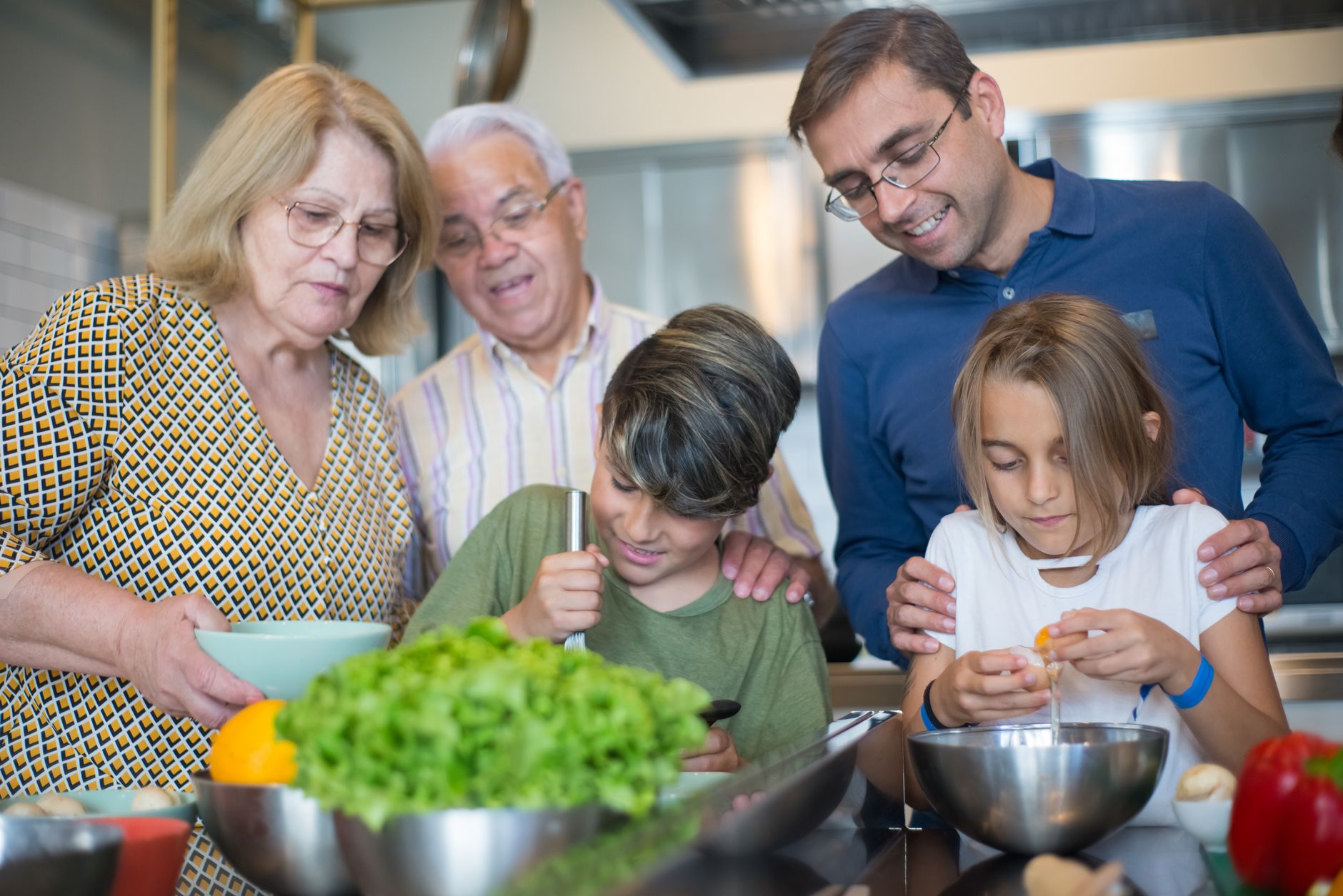 A joyful multi-generational family bonding while preparing a meal in the kitchen.