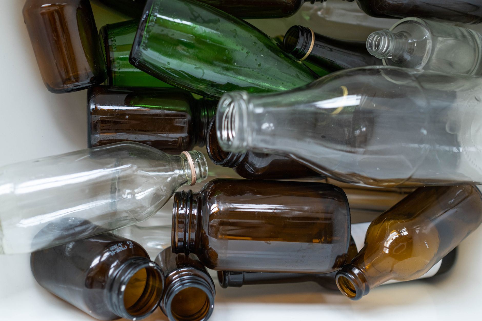 A detailed view of assorted recyclable glass bottles, showcasing their potential for reuse and environmental sustainability.