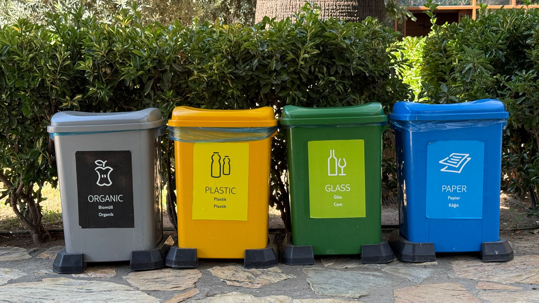 Colorful recycling bins for waste segregation in a park in İzmir, Türkiye.