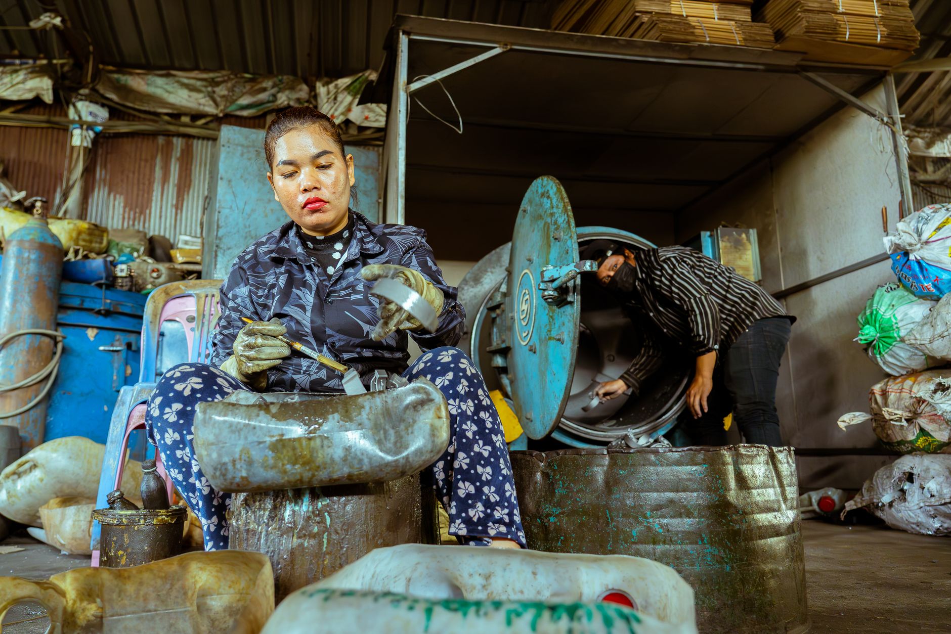 Workers in a recycling plant sorting materials, emphasizing teamwork and sustainability.